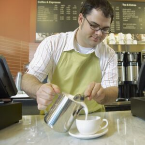 barista pouring cappuccino