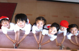 Japanese children looking up at the camera.