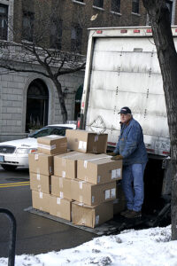Man with shipment of boxes. Photo: McGraw-Hill Education.