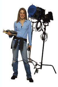 Stage assistant standing with stage light. Photo: Comstock/Getty Images