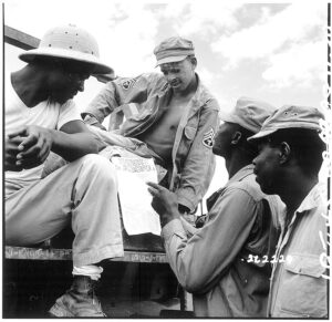 Troops in Burma stop work briefly to read President Truman's Proclamation of Victory in Europe'. Photo: National Archives and Records Administration (NWDNS-111-SC-262229)