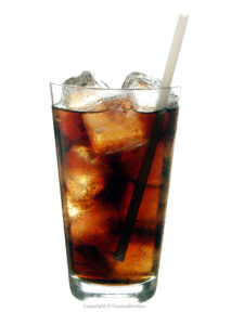 Cola with ice cubes and straw in a glass against a white background. Copyright © Foodcollection. MHE World.