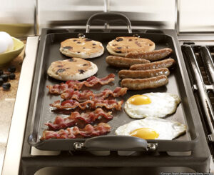 Breakfast cooking on griddle on stove. ©Carolyn Taylor Photography/Getty Images. MHE Canada;MHE USA.