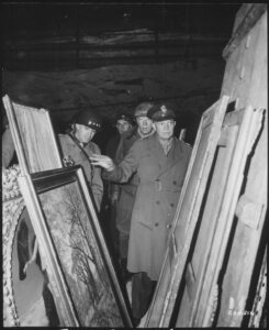 General Dwight D. Eisenhower, Supreme Allied Commander, accompanied by General Omar N. Bradley, and Lieutenant General George S. Patton, Jr., inspects art treasures stolen by Germans and hidden in salt mine in Merkers, Germany. 12 April 1945. Series: Signal Corps Photographs of American Military Activity, compiled 1754 - 1954. Department of Defense. Department of the Army. Office of the Chief Signal Officer. (09/18/1947 - 02/28/1964). Record group: Record Group 111: Records of the Office of the Chief Signal Officer, 1860 - 1985