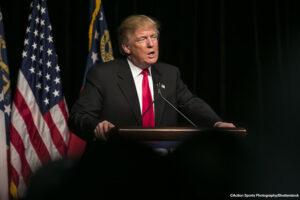 Donald Trump speaking at a podium