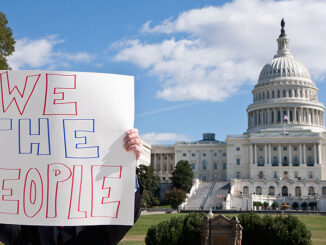 a protestor in front of the U.S. Capitol building