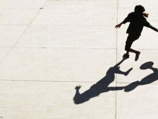 Two teenage boys playing basketball