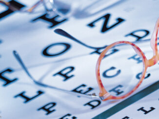 Eye exam chart with glasses on top