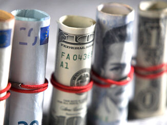 Close-up of paper currency rolls. Photo: Glow Images