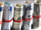 Close-up of paper currency rolls. Photo: Glow Images