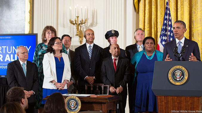 050115_02P_FS President Barack Obama delivers remarks before he signs an executive order regarding further amendments to Executive Order 11478, Equal Employment Opportunity in the Federal Government, and Executive Order 11246, Equal Employment Opportunity, to protect LGBT employees from workplace discrimination, in the East Room of the White House, July 21, 2014. Photo: Official White House Photo by Pete Souza
