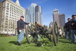 Union soldier reenactors pose with cannon.