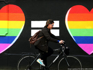 A woman cycles past a marriage equality mural in the Liberties area of Dublin, as Ireland should become the international advocate for gay rights, a key figure in spearheading the country's vote for same-sex marriage has said. Picture date: Sunday May 24, 2015.