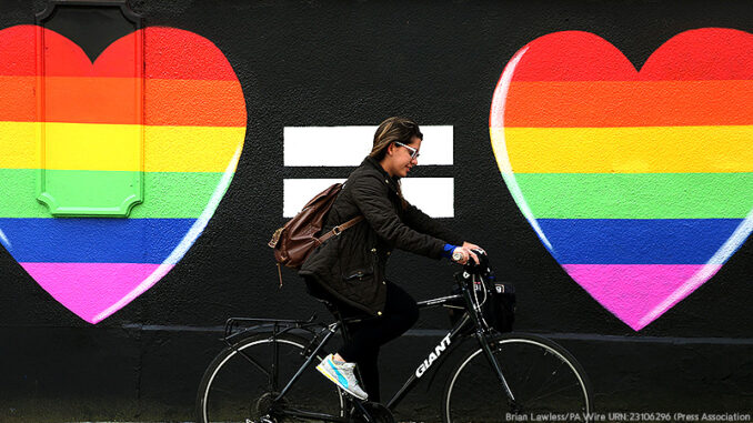 052915_03P_FS A woman cycles past a marriage equality mural in the Liberties area of Dublin, as Ireland should become the international advocate for gay rights, a key figure in spearheading the country's vote for same-sex marriage has said. Picture date: Sunday May 24, 2015.