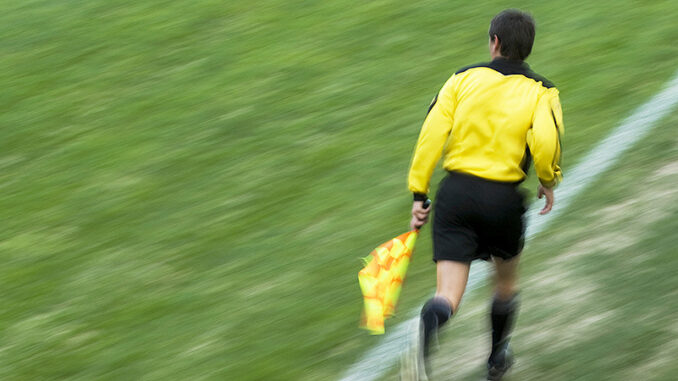 060415_04P_FS Referee running on a football pitch. Photo: Glow Images