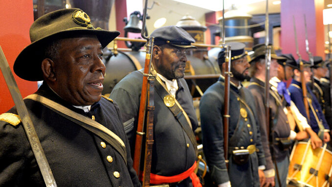 062215_02P_FS Black Civil War re-enactors Lt James Hayes (from left), Samuel Stephenson and Marvin-Alonzo Greer are shown during a Juneteenth celebration at the Atlanta Cyclorama and Civil War Museum. Photo: AP Photo/Atlanta Journal-Constitution, Kent D. Johnson