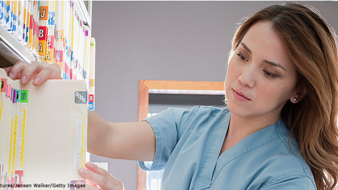 93259060 Head and shoulders view of an Asian nurse filing medical charts. DreamPictures/Jensen Walker/Getty Images. Blend Images. single image purchase by SEG from Getty Images Oct-14 (PA4). MHE Canada MHE USA