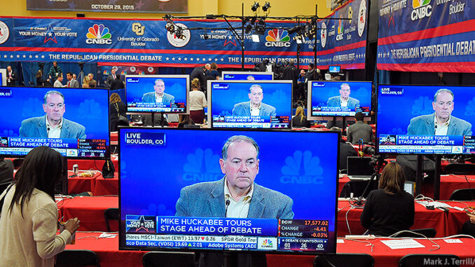 AP_28416506888 Republican presidential candidate Mike Huckabee appears on a series of television monitors in the media center before the start of the CNBC Republican presidential debate at the University of Colorado, Wednesday, Oct. 28, 2015, in Boulder, Colo. (AP Photo/Mark J. Terrill).Mark J. Terrill/AP Images. http://www.apimages.com/metadata/Index/GOP-2016-Debate/371aa866464a491288dbd0e7228e78af/1/0