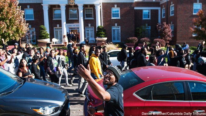 AP_785778903009 Activist and graduate student Jonathan Butler gestures to invite bystanders to join a "We Are Not Afraid" march including local and regional Concerned Student 1950 supporters Friday, Nov. 13, 2015 while in Greek town on Richmond Avenue on the University of Missouri campus in Columbia, Mo. (Daniel Brenner/Columbia Daily Tribune via AP) MANDATORY CREDIT. Daniel Brenner/Columbia Daily Tribune/AP Images. http://www.apimages.com/metadata/Index/University-Of-Missouri-Turmoil/6d659b410779467fa45a66c88ae04a19/1/0.
