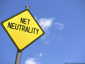 Low-angle view of a yellow warning sign with the text 'Net Neutrality' against a blue sky.© Martin McCarthy/iStock/Getty Images. MHE Canada MHE