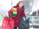 Woman carrying shopping bags on snowy street. ©Ariel Skelley/Blend Images LLC. MHE World