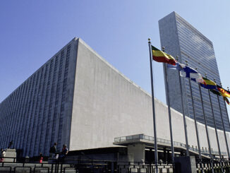 Low-angle view of the United Nations building complex, New York City, USA, with unrecognizable people milling around. Purestock/SuperStock. MHE World.