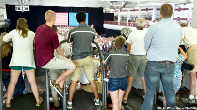 b1a5172 Audience members standing on treadmills listen as President Barack Obama makes remarks at the University of Wisconsin at La Crosse in La Crosse, Wisc., July 2, 2015. © Official White House Photo by Pete Souza. https://www.whitehouse.gov/photos-and-video/photogallery/july-2015-photo-day.