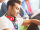 University student using digital tablet in lounge. Robert Daly/Glow Images. MHE World.