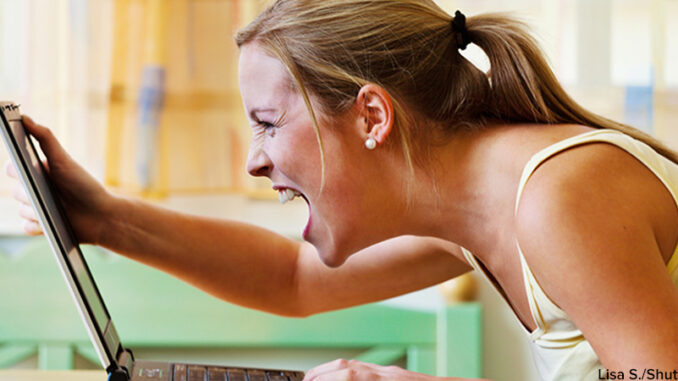 84358267 A woman angry over your computer. Problems with hardware, software and Internet shopping. Lisa S./Shutterstock. MHE World.