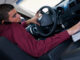 Side profile of a businessman using a laptop in a car. Glow Images. MHE World