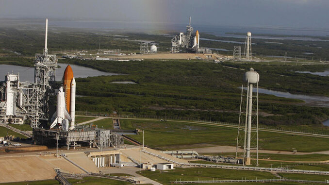 053116_01P_FS Space shuttle Atlantis (foreground) sits on Launch Pad A and Endeavour on Launch Pad B at NASA's Kennedy Space Center in Florida. At the left of each shuttle are the open rotating service structures with the payload changeout rooms revealed. The rotating service structures provide protection for weather and access to the shuttle. For the first time since July 2001; two shuttles are on the launch pads at the same time. Endeavour will stand by at pad B in the unlikely event that a rescue mission is necessary during Atlantis' upcoming STS-125 mission to repair NASA's Hubble Space Telescope. Troy Cryder/NASA. MHE World