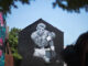 A pedestrian passes a mural of Muhammad Ali painted on the side of a building Monday, June 6, 2016, in Louisville, Ky.