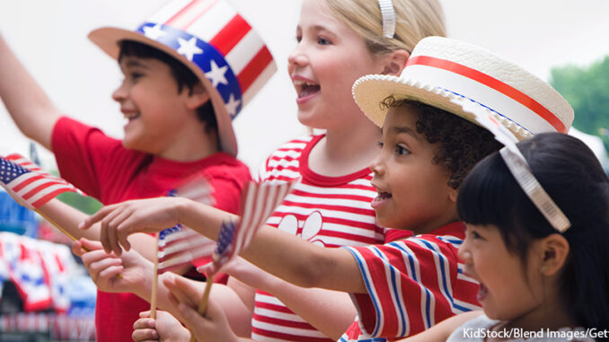 070516_FS_01P Waist-length profile view of four patriotically-dressed children (6-9) cheering during a Fourth of July parade and celebration, West New York, New Jersey. KidStock/Blend Images/Getty Images. MHE Canada;MHE USA.