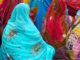 Back view of seated women wearing their finest and most colorful saris in wedding ceremony, Pushkar, India. Joseph Tursi/Getty Images. MHE Canada;MHE USA.