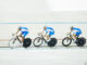 Full-length profile view of four cyclists racing around a velodrome track. Chris Ryan/Getty Images. MHE Canada;MHE USA.