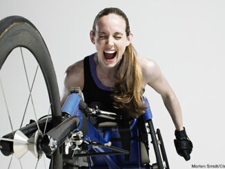 Overjoyed female wheelchair athlete,