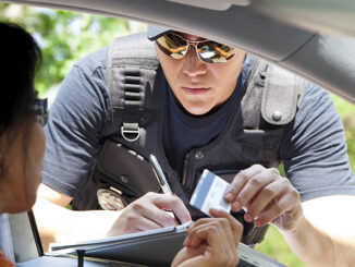 Crime: Policeman gives driver a traffic ticket. Pamela Moore/Getty Images. MHE Canada;MHE USA