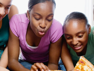 Five Teenagers Eating Pizza. Corbis Premium RF/Alamy. MHE World
