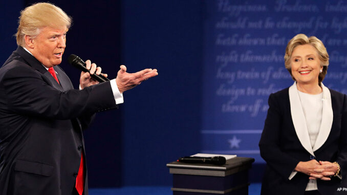 101216_03P_FS Republican presidential nominee Donald Trump speaks with Democratic presidential nominee Hillary Clinton during the second presidential debate at Washington University in St. Louis, Sunday, Oct. 9, 2016.