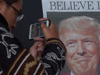 Zheng Gao of Shanghi, China, photographs the front pages of newspapers on display outside the Newseum in Washington, Wednesday, Nov., 9, 2016, the day after Donald Trump won the presidency. Credit: Susan Walsh/AP Images