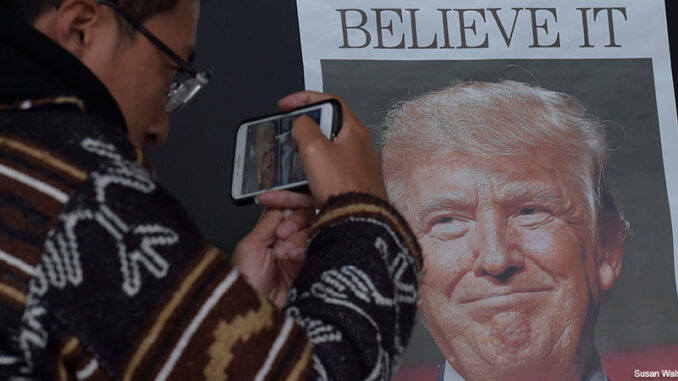 111516_02P_FS Zheng Gao of Shanghi, China, photographs the front pages of newspapers on display outside the Newseum in Washington, Wednesday, Nov., 9, 2016, the day after Donald Trump won the presidency. Credit: Susan Walsh/AP Images