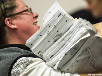 Election workers recount votes on Flint ballots, as they begin the process of a statewide recount on Wednesday, Dec. 7, 2016 at Genesee County Administration Building in Flint, Michigan
