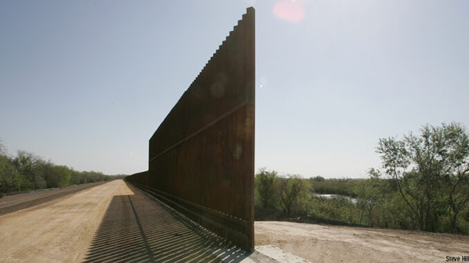 20117_02P_FS Refuge border wall, Lower Rio Grande Valley National Wildlife Refuge, TX (Mexico and the Rio Grande River on the right). Credit: Steve Hillebrand/USFWS