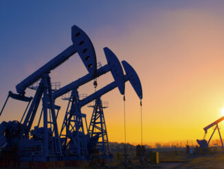 View of oil pumpjacks silhouetted against a sunset in Texas