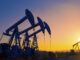 View of oil pumpjacks silhouetted against a sunset in Texas