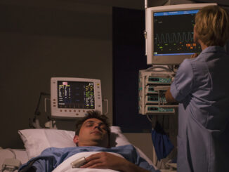 Nurse tending patient in intensive care