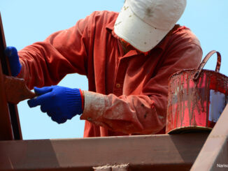 Mason was painted in oil on the steel roof structure using a paint brush to prevent rust and to the beauty of the roof.