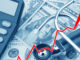 View of a rising red graph showing the high cost of health care atop USD bank notes, a stethoscope and calculator