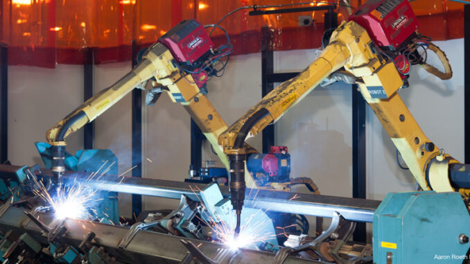 040517_02P_FS Three-quarter length view of a pair of metal inert gas welding robots at John Deere Harvester Works, East Moline, Illinois.