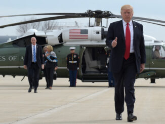 President Donald Trump gives a thumb-up as he walks from Marine to Air Force One at General Mitchell International Airport in Milwaukee